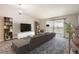 Spacious living room featuring a large sectional sofa, entertainment center, and balcony access at 720 S Clinton St # 2D, Denver, CO 80247