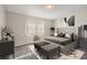 Serene main bedroom showcasing a tufted headboard, soft lighting, and comfortable furnishings at 720 S Clinton St # 2D, Denver, CO 80247