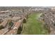Aerial view of townhomes backing up to green space with a pond and mature trees at 3026 W Prentice Ave # H, Littleton, CO 80123