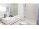 Bright bathroom with granite countertop, vessel sink, and tiled shower and tub at 3026 W Prentice Ave # H, Littleton, CO 80123