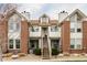 Brick and siding two-story townhome with dual chimneys and a private entrance at 3026 W Prentice Ave # H, Littleton, CO 80123