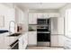 Well-appointed kitchen with sleek appliances, white cabinetry, and granite countertops at 3026 W Prentice Ave # H, Littleton, CO 80123