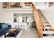 Bright living space features a loft, open staircase, and view into the updated kitchen at 3026 W Prentice Ave # H, Littleton, CO 80123