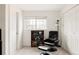 Comfortable room with plush chair, bookshelf, and large window at 3026 W Prentice Ave # H, Littleton, CO 80123