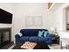 Comfortable living room with a cozy fireplace and a view to the open concept kitchen at 3026 W Prentice Ave # H, Littleton, CO 80123