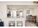 Open concept living space with bar seating and views of the adjacent living and dining areas at 3026 W Prentice Ave # H, Littleton, CO 80123