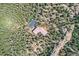 Aerial view of a home with a private driveway surrounded by a lush green forest at 30671 Bearcat Trl, Conifer, CO 80433