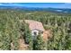 Expansive aerial view of a secluded property with mature trees creating a private oasis at 30671 Bearcat Trl, Conifer, CO 80433