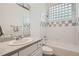 Bathroom with a tiled shower-over-tub, white tile and countertops and clean finishes at 30671 Bearcat Trl, Conifer, CO 80433
