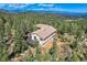 Hillside home with deck surrounded by mature trees and picturesque mountain views at 30671 Bearcat Trl, Conifer, CO 80433