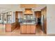Modern kitchen features custom cabinets, granite countertops, stainless steel appliances, and an ample-sized island at 30671 Bearcat Trl, Conifer, CO 80433