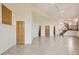 Large open floorplan with tile floors, light walls, and wood doors at 30671 Bearcat Trl, Conifer, CO 80433
