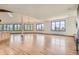 Expansive living room featuring hardwood floors, abundant natural light, and scenic views from the large windows at 30671 Bearcat Trl, Conifer, CO 80433
