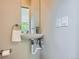Chic powder room featuring a wall-mounted sink, modern fixtures, and neutral-toned walls at 1895 York St, Denver, CO 80206