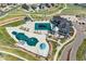 An aerial view showcases an amenity center with a pool, playground, manicured lawns, and inviting lounging areas at 7051 S White Crow Way, Aurora, CO 80016