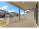 Large back porch with white railing, offering ample outdoor living space at 7051 S White Crow Way, Aurora, CO 80016