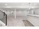 Spacious finished basement featuring plush carpeting, modern lighting, and a convenient wet bar area at 7051 S White Crow Way, Aurora, CO 80016