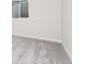 A close up of basement carpeting, showing the baseboard and a small window at 7051 S White Crow Way, Aurora, CO 80016