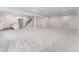 Large finished basement with modern design, including stairs, and partial kitchenette/bar area at 7051 S White Crow Way, Aurora, CO 80016