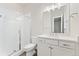Clean and modern bathroom with a glass-enclosed shower, vanity with countertop, and wood-look flooring at 7051 S White Crow Way, Aurora, CO 80016