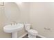 Half-bathroom featuring single sink and white toilet at 7051 S White Crow Way, Aurora, CO 80016