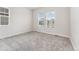 Bedroom with neutral carpet, two large windows, and ample natural light at 7051 S White Crow Way, Aurora, CO 80016