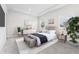 Stylishly furnished bedroom with a plush bed, decorative accents, and ample natural light from large windows at 7051 S White Crow Way, Aurora, CO 80016