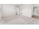 Spacious carpeted bedroom featuring a view of the en suite bathroom, and white walls at 7051 S White Crow Way, Aurora, CO 80016
