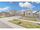 Charming single-Gathering home with brick facade, well-manicured lawn, and a two-car garage on a sunny day at 7051 S White Crow Way, Aurora, CO 80016