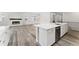 Bright open kitchen flows into the living room with fireplace, featuring stainless appliances at 7051 S White Crow Way, Aurora, CO 80016