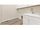 Laundry room with sink, and modern floors at 7051 S White Crow Way, Aurora, CO 80016