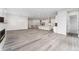 Spacious open-concept living area with hardwood floors, modern fireplace, and staircase with black railing at 7051 S White Crow Way, Aurora, CO 80016