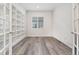 Home office with built-in shelving, bright natural light and stylish modern floors at 7051 S White Crow Way, Aurora, CO 80016