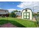 Backyard view showcasing shed with green trim, lush green lawn, and brick-paved patio area at 334 S 7Th Ave, Brighton, CO 80601