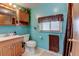 A bathroom with a sink and toilet and blue walls at 334 S 7Th Ave, Brighton, CO 80601