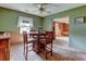 Inviting dining room with wooden table and chairs, complemented by neutral wall paint, carpet, and ample natural light at 334 S 7Th Ave, Brighton, CO 80601