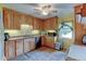 Bright kitchen with honey oak cabinets, tile flooring, ample counter space, and natural light, perfect for cooking at 334 S 7Th Ave, Brighton, CO 80601