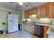 A bright kitchen featuring wood cabinetry, tile flooring, and modern appliances at 334 S 7Th Ave, Brighton, CO 80601