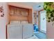 A laundry room with side-by-side washer and dryer and storage at 334 S 7Th Ave, Brighton, CO 80601