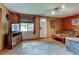 Cozy living room with plush carpet, wood entertainment center, and a sunlit window, creating an inviting space at 334 S 7Th Ave, Brighton, CO 80601
