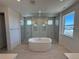 Luxurious bathroom featuring a soaking tub, a large glass shower, and modern fixtures at 6036 Riesberg Ln, Castle Rock, CO 80104