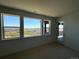 Light-filled bedroom with stunning views, large windows, and access to a private deck at 6036 Riesberg Ln, Castle Rock, CO 80104