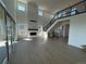Spacious great room features soaring ceilings, a modern fireplace, large windows, and wood flooring at 6036 Riesberg Ln, Castle Rock, CO 80104
