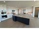 Gourmet kitchen featuring a large island with granite countertops, stainless steel appliances, and ample cabinetry at 6036 Riesberg Ln, Castle Rock, CO 80104