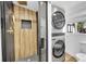 Modern bathroom features a unique tile shower and stackable washer and dryer at 3064 S Galapago St, Englewood, CO 80110