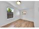Cozy bedroom with natural light, wood-look floors, and neutral walls at 3064 S Galapago St, Englewood, CO 80110