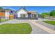 Charming home featuring stylish black and white exterior with modern rock landscaping and synthetic turf at 3064 S Galapago St, Englewood, CO 80110