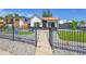 Charming home with a black fence, modern rock landscaping, and synthetic turf at 3064 S Galapago St, Englewood, CO 80110