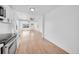 Bright white kitchen with stainless steel appliances and open layout flowing into the dining area at 3064 S Galapago St, Englewood, CO 80110