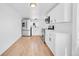 Bright kitchen featuring white cabinets, stainless steel appliances, and light wood floors at 3064 S Galapago St, Englewood, CO 80110